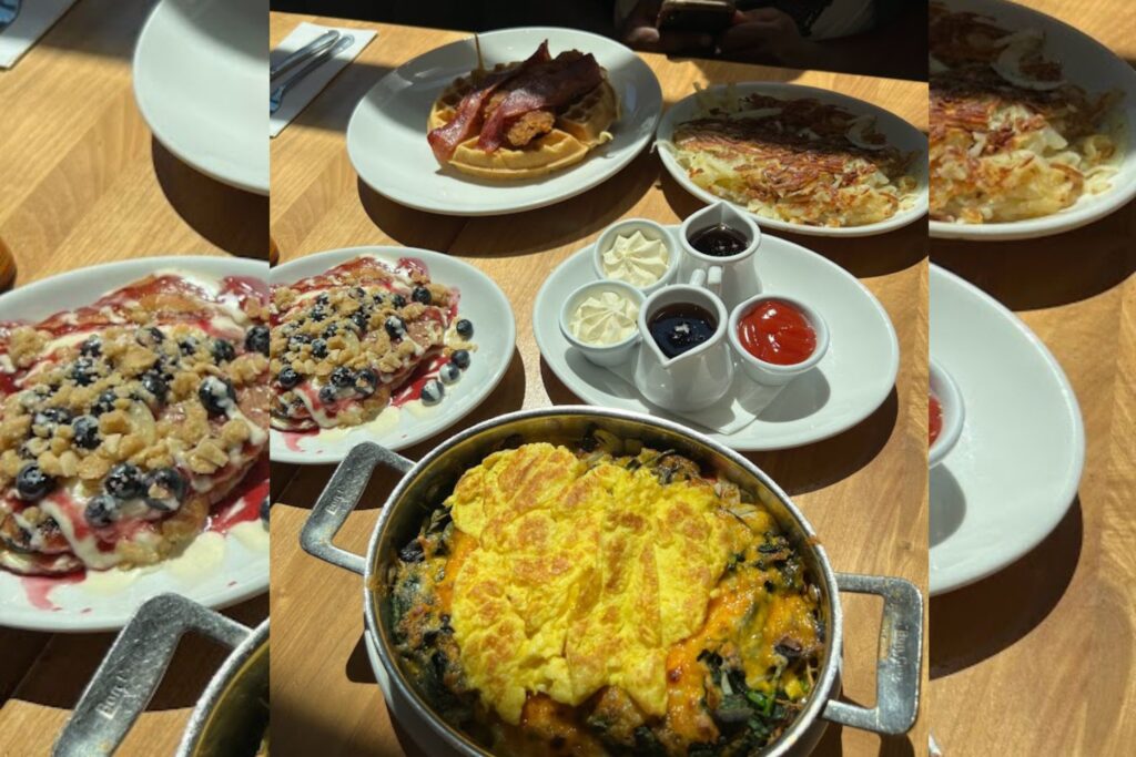 Experiencing Chicago 2022 3 Brunch spread at Wildberry Pancakes and Cafe in Chicago featuring berry pancakes, omelette skillet, waffles, and hash browns